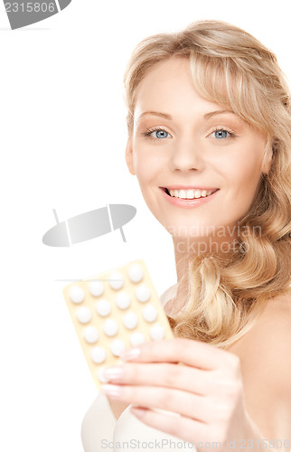 Image of young woman with pills