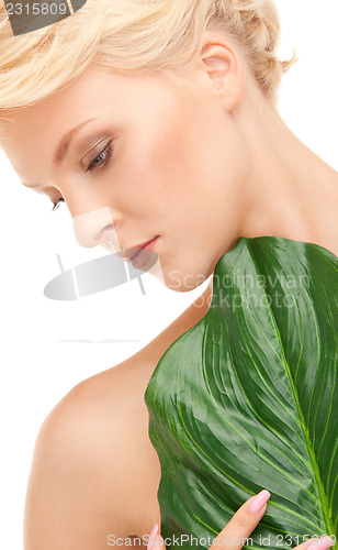 Image of woman with green leaf