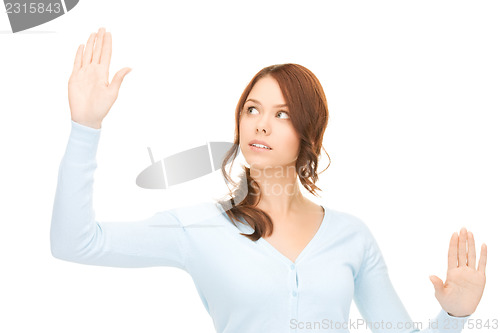 Image of businesswoman working with something imaginary