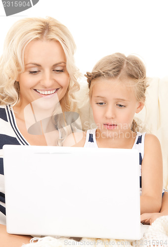 Image of happy mother and child with laptop computer