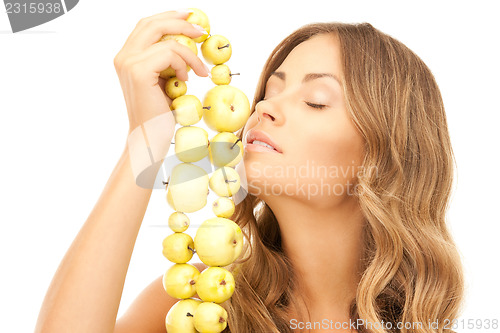 Image of lovely woman with green apples