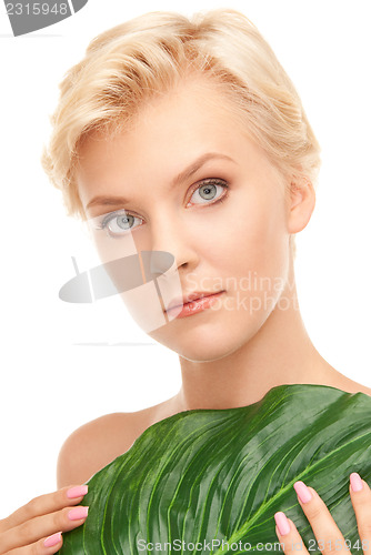 Image of woman with green leaf