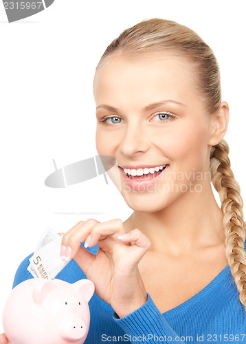 Image of lovely woman with piggy bank and money