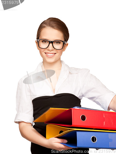 Image of young attractive businesswoman with folders