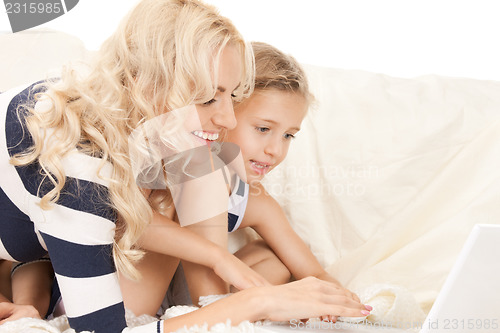 Image of happy mother and child with laptop computer