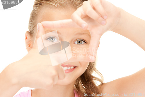 Image of pretty girl creating a frame with fingers