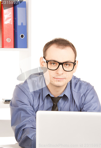 Image of businessman with laptop computer in office