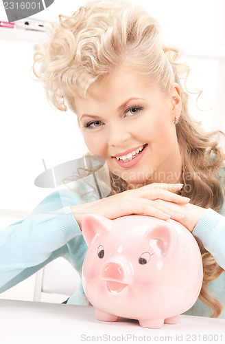 Image of lovely woman with piggy bank
