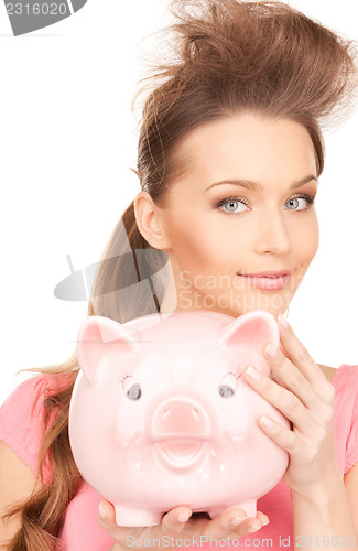Image of lovely woman with piggy bank