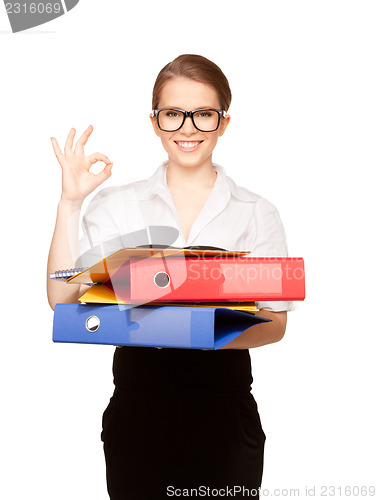 Image of young attractive businesswoman with folders