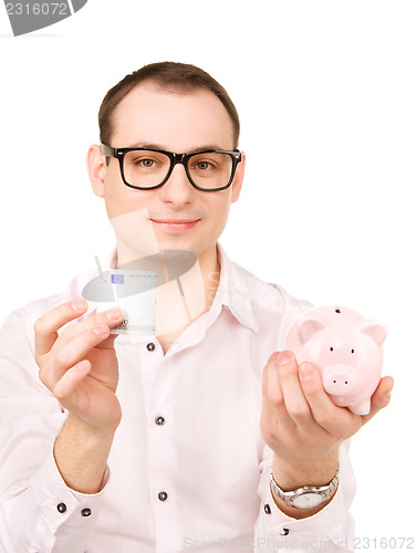 Image of businessman with piggy bank and money