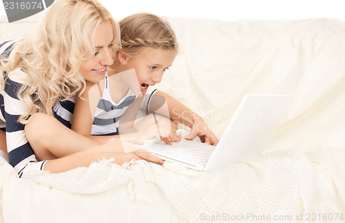 Image of happy mother and child with laptop computer
