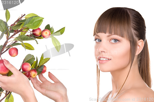 Image of lovely woman with apple twig