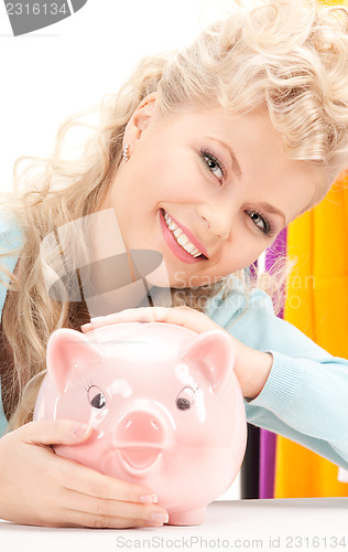 Image of lovely woman with piggy bank