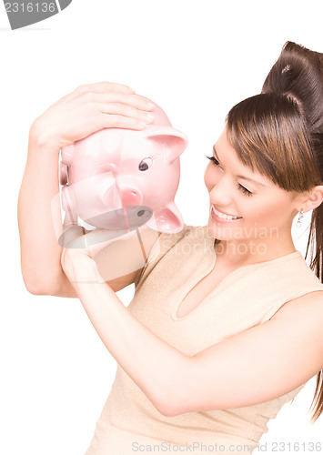 Image of lovely woman with piggy bank