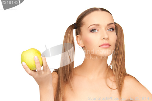 Image of young beautiful woman with green apple