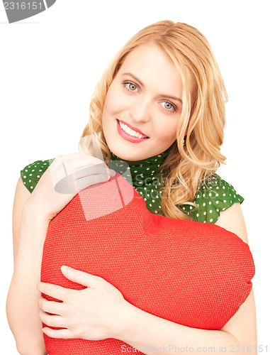 Image of woman with red heart-shaped pillow