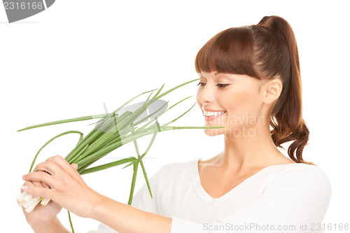 Image of beautiful housewife with spring onions over white
