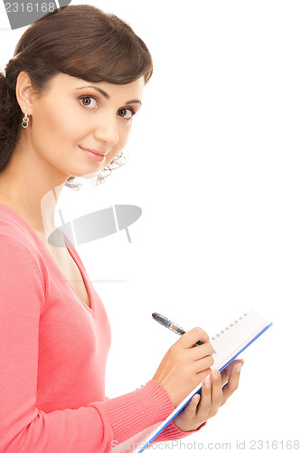 Image of young attractive businesswoman with notebook