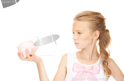 Image of lovely teenage girl with piggy bank