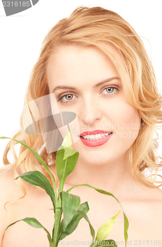 Image of woman with sprout over white