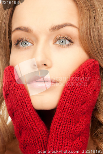 Image of beautiful woman in red mittens 