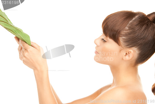 Image of woman with green leaf
