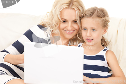 Image of happy mother and child with laptop computer