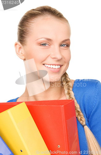 Image of young attractive businesswoman with folders