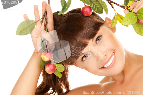 Image of happy woman with apple twig