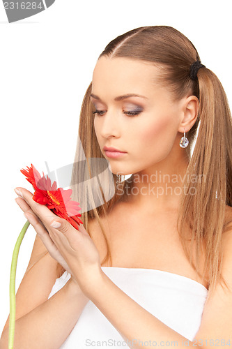 Image of woman in towel with red flower