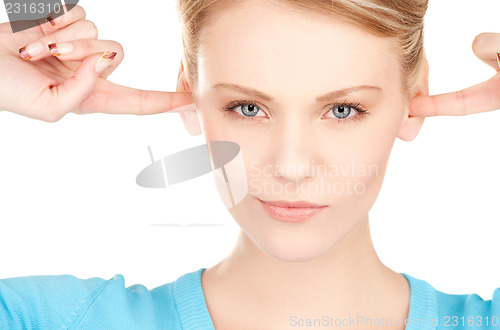 Image of woman with fingers in ears