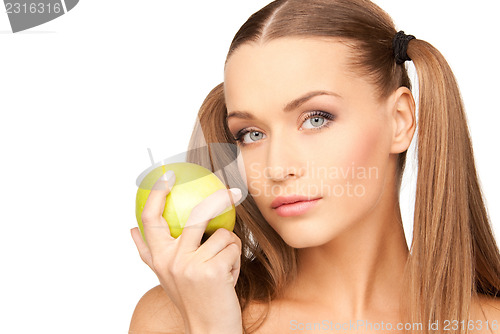 Image of young beautiful woman with green apple