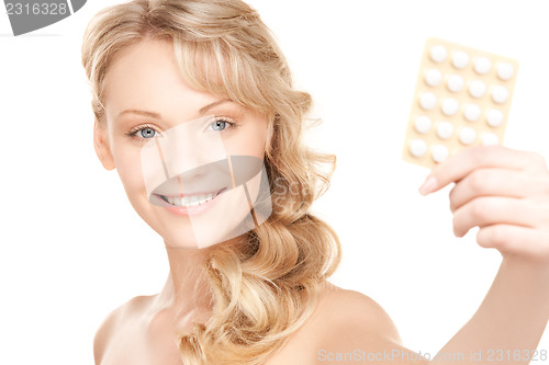 Image of young woman with pills