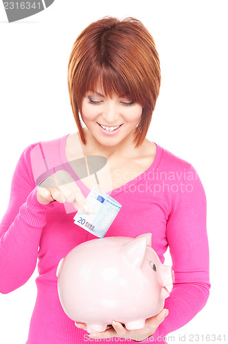 Image of lovely woman with piggy bank and money