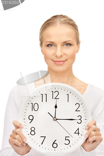 Image of woman holding big clock