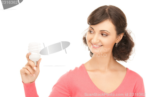 Image of woman holding energy saving bulb