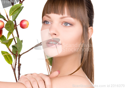Image of lovely woman with apple twig
