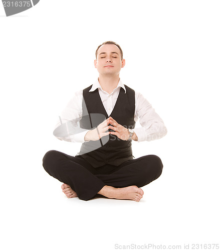 Image of businessman sitting in lotus pose