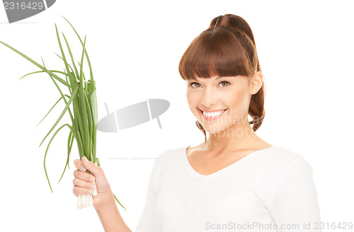 Image of beautiful housewife with spring onions over white