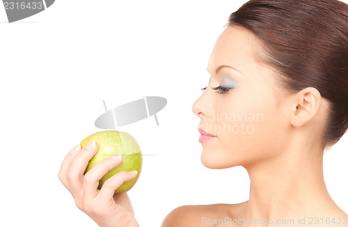 Image of young beautiful woman with green apple