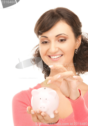 Image of lovely woman with piggy bank and money