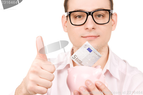 Image of businessman with piggy bank and money