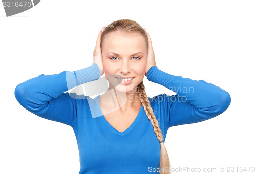 Image of smiling woman with hands over ears