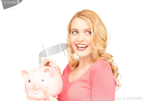 Image of lovely woman with piggy bank and money