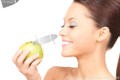Image of young beautiful woman with green apple