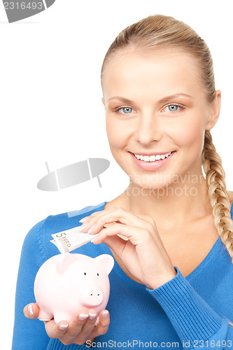 Image of lovely woman with piggy bank and money