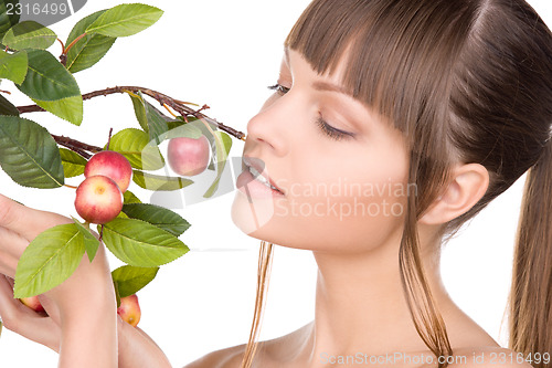 Image of lovely woman with apple twig