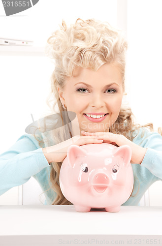 Image of lovely woman with piggy bank