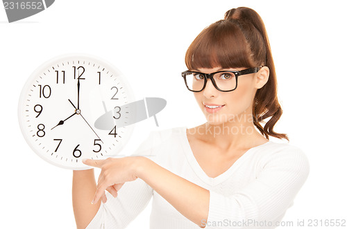 Image of woman holding big clock